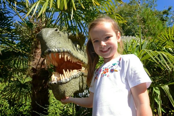 girl smiling with a dinosaur