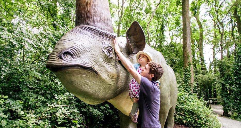 dad and daughter stroking dinosaur