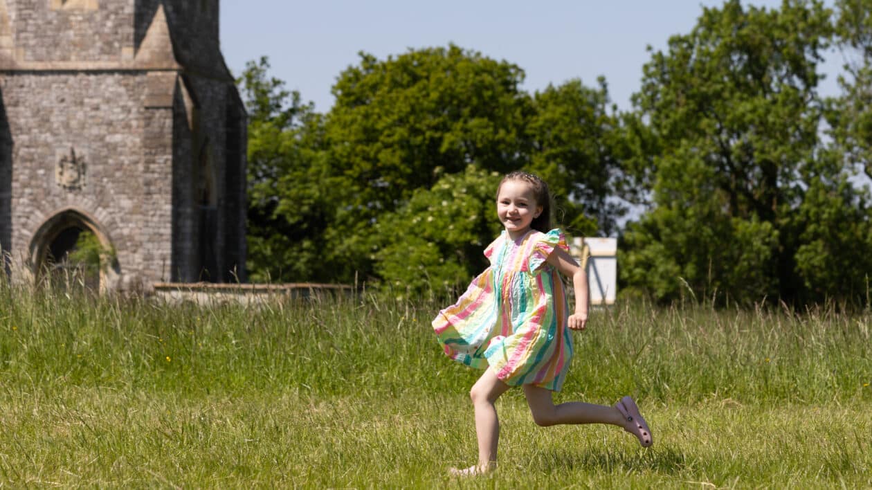 little girl running on the grass at springfest