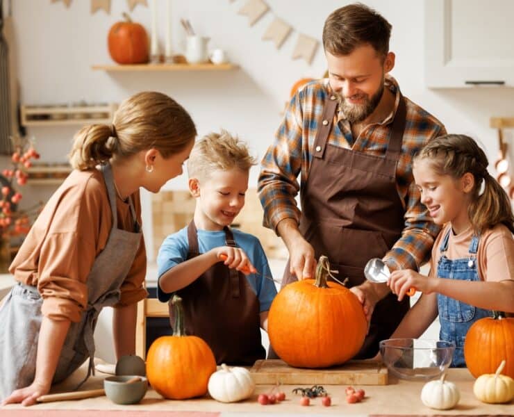 family carving pumpkins together