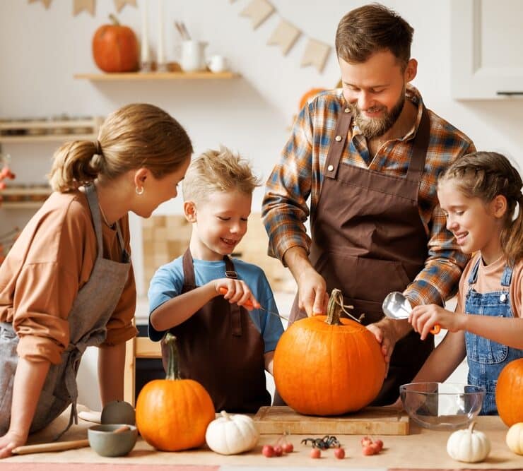 family carving pumpkins together