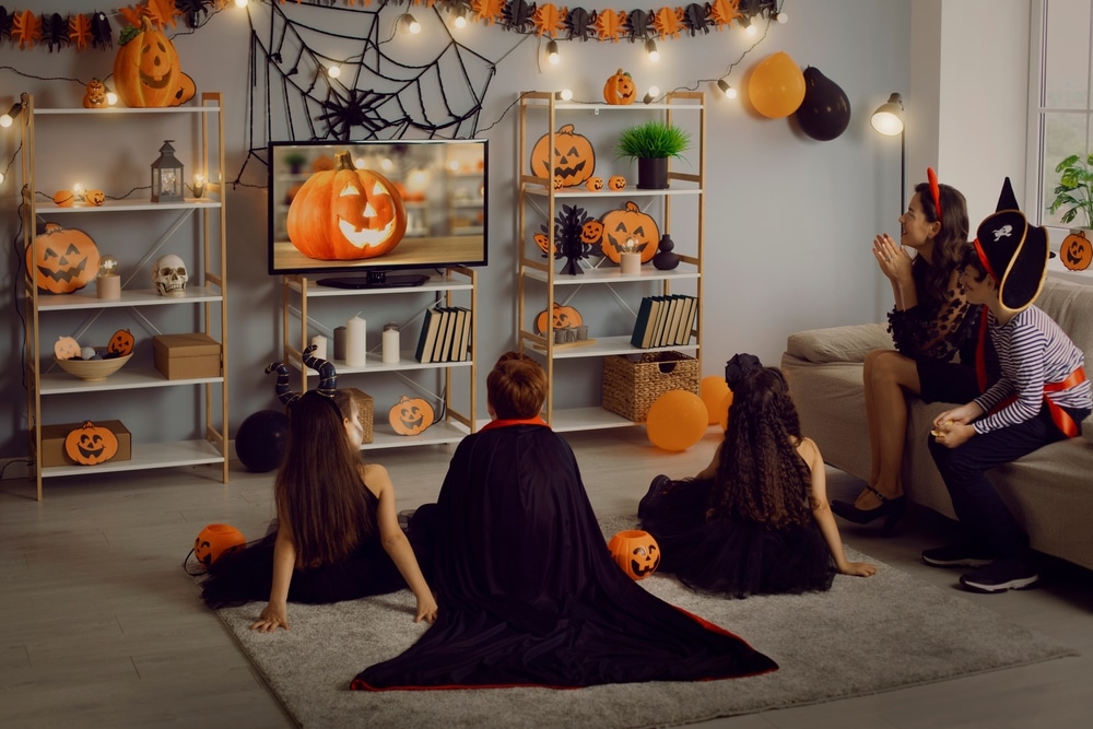 kids watching films dressed up for halloween