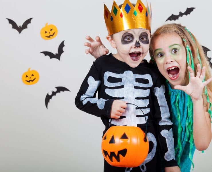 a boy and girl in halloween costumes