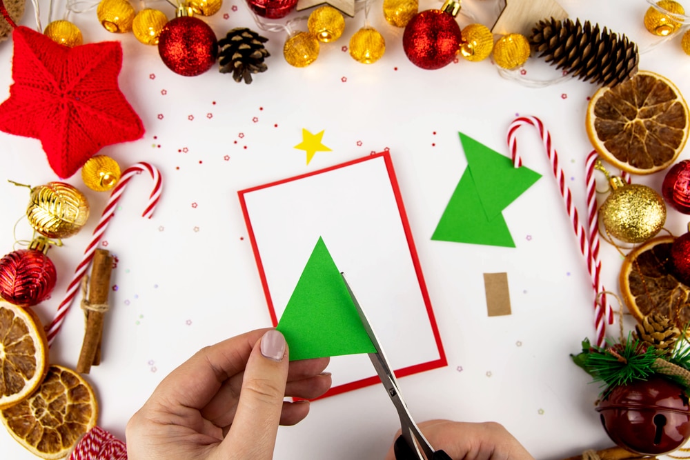 someone making a christmas tree card