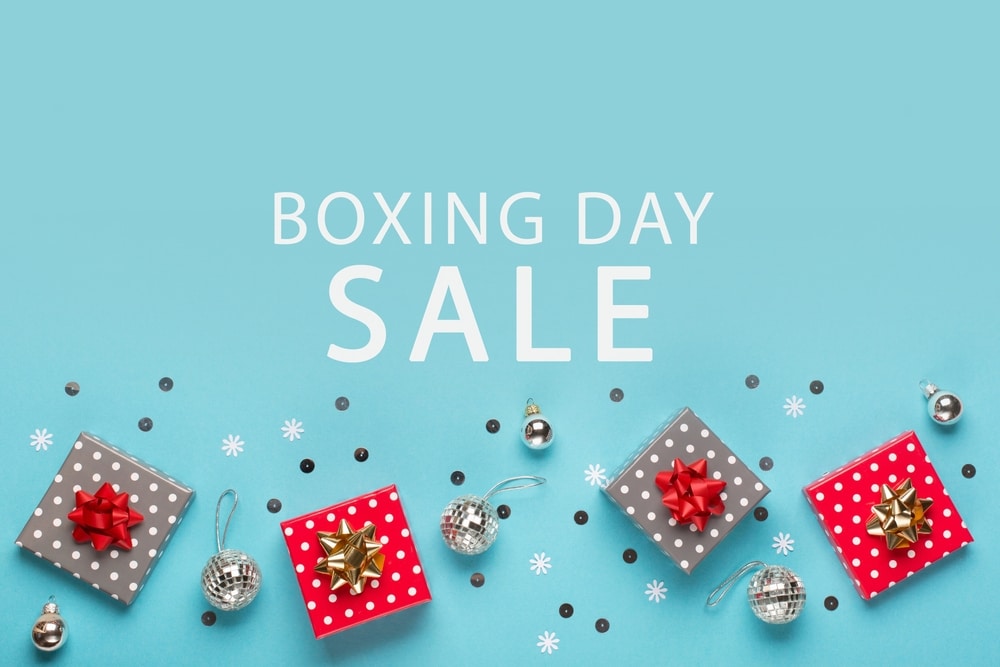 a boxing day sale sign with gifts underneath