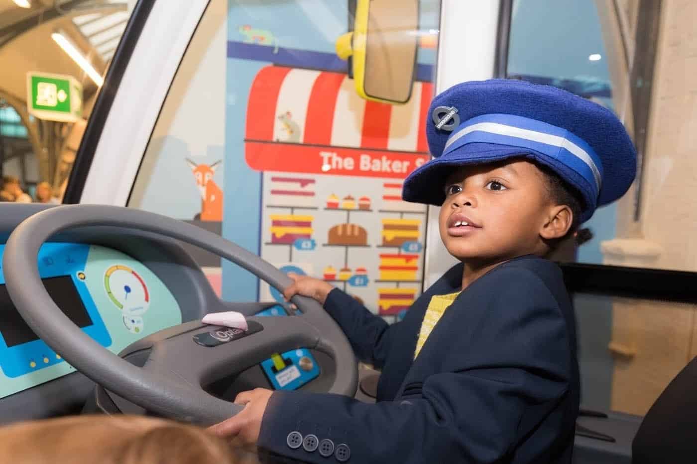 Toddler driving bus in transport museum London