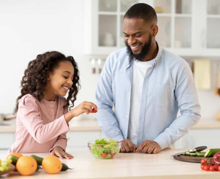 Dad and daughter making salad