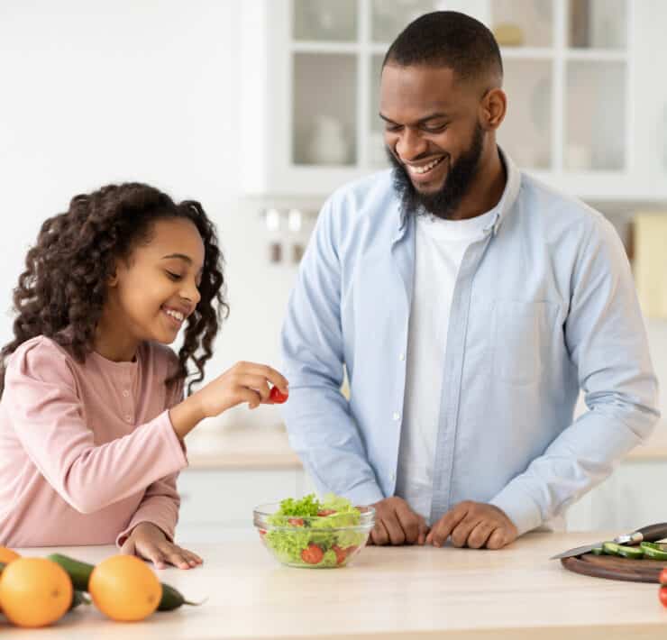Dad and daughter making salad