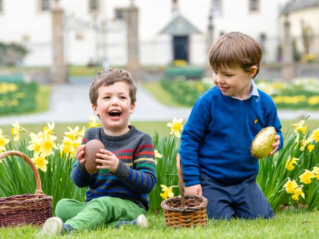 two boys with a basket of easter eggs