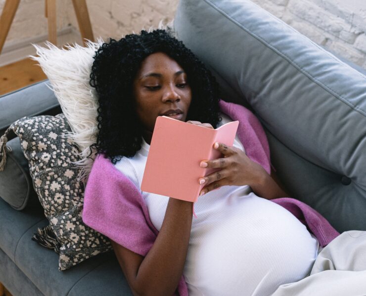 pregnant lady writing a list of unique baby names in diary