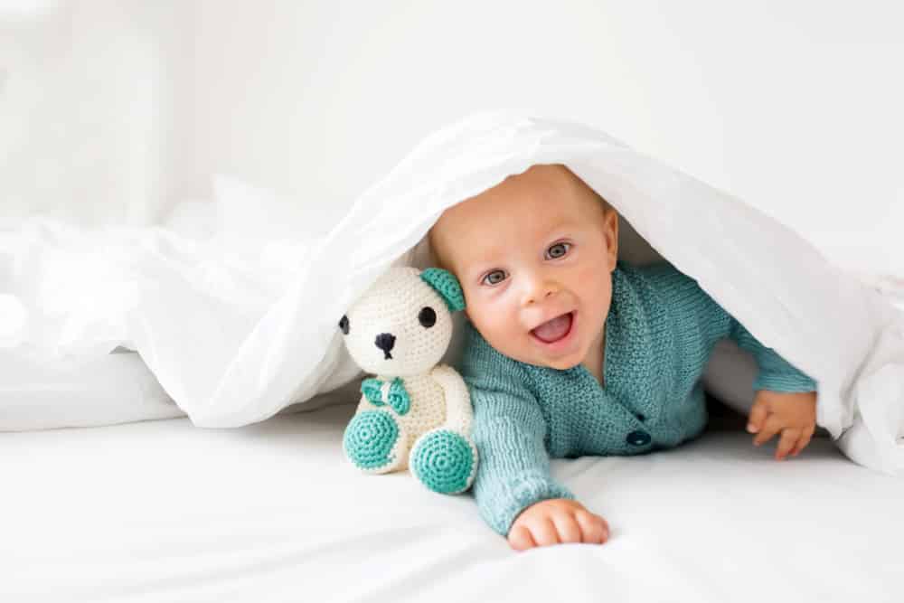 cute baby boy under blanket