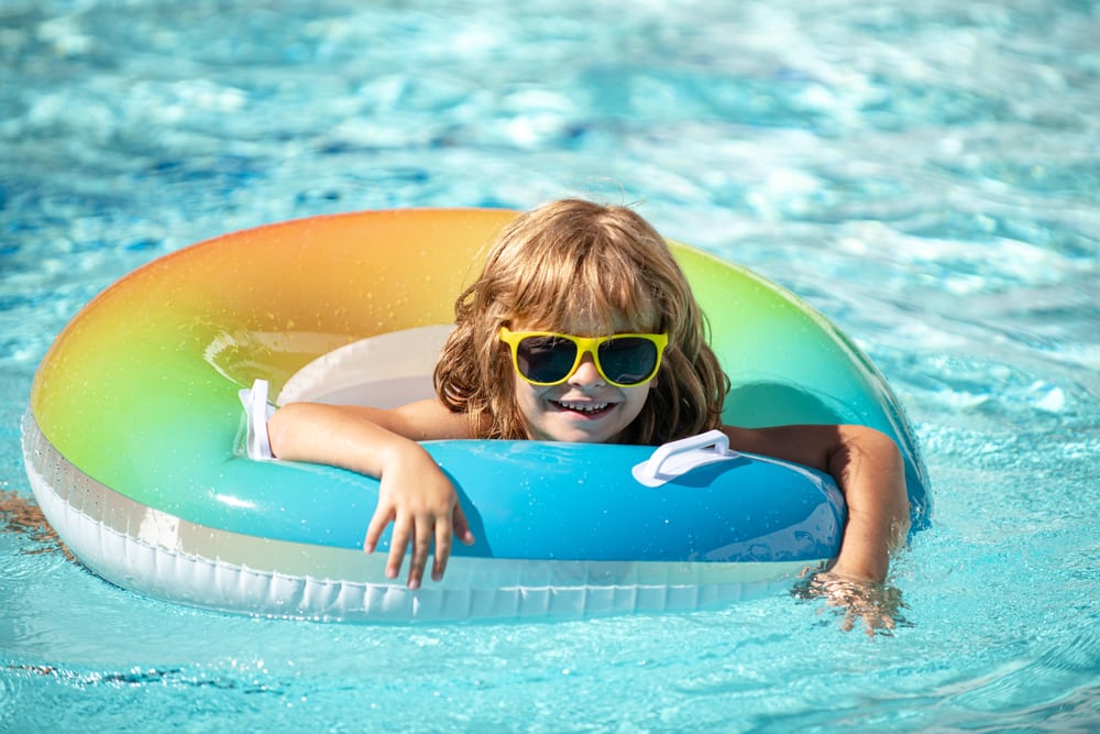 girl swimming with a pool floaty