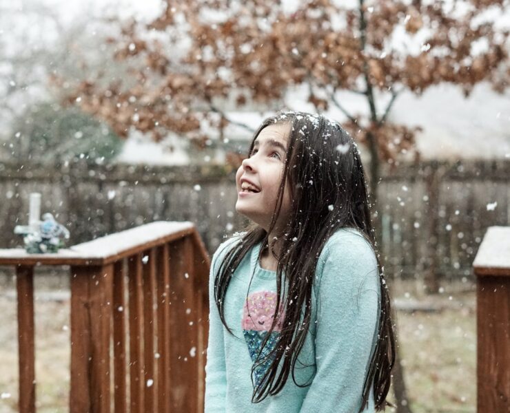 a girl watching it snow