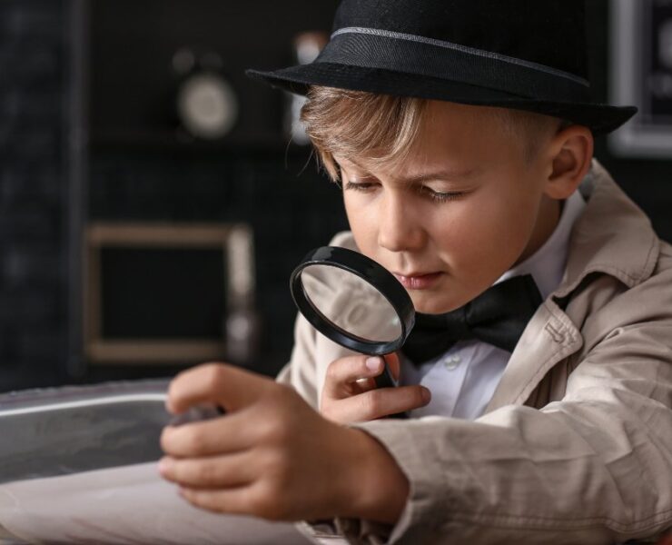 little boy looking in a microscope