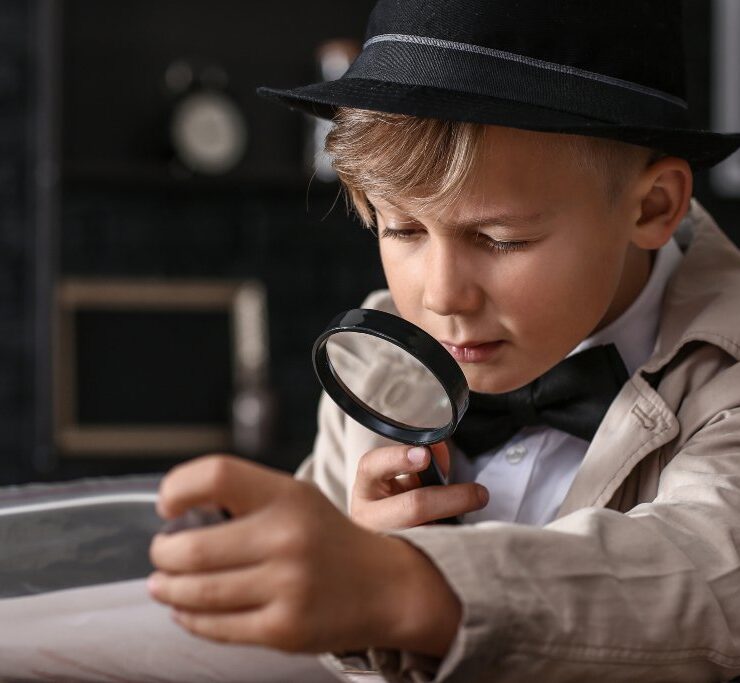 little boy looking in a microscope