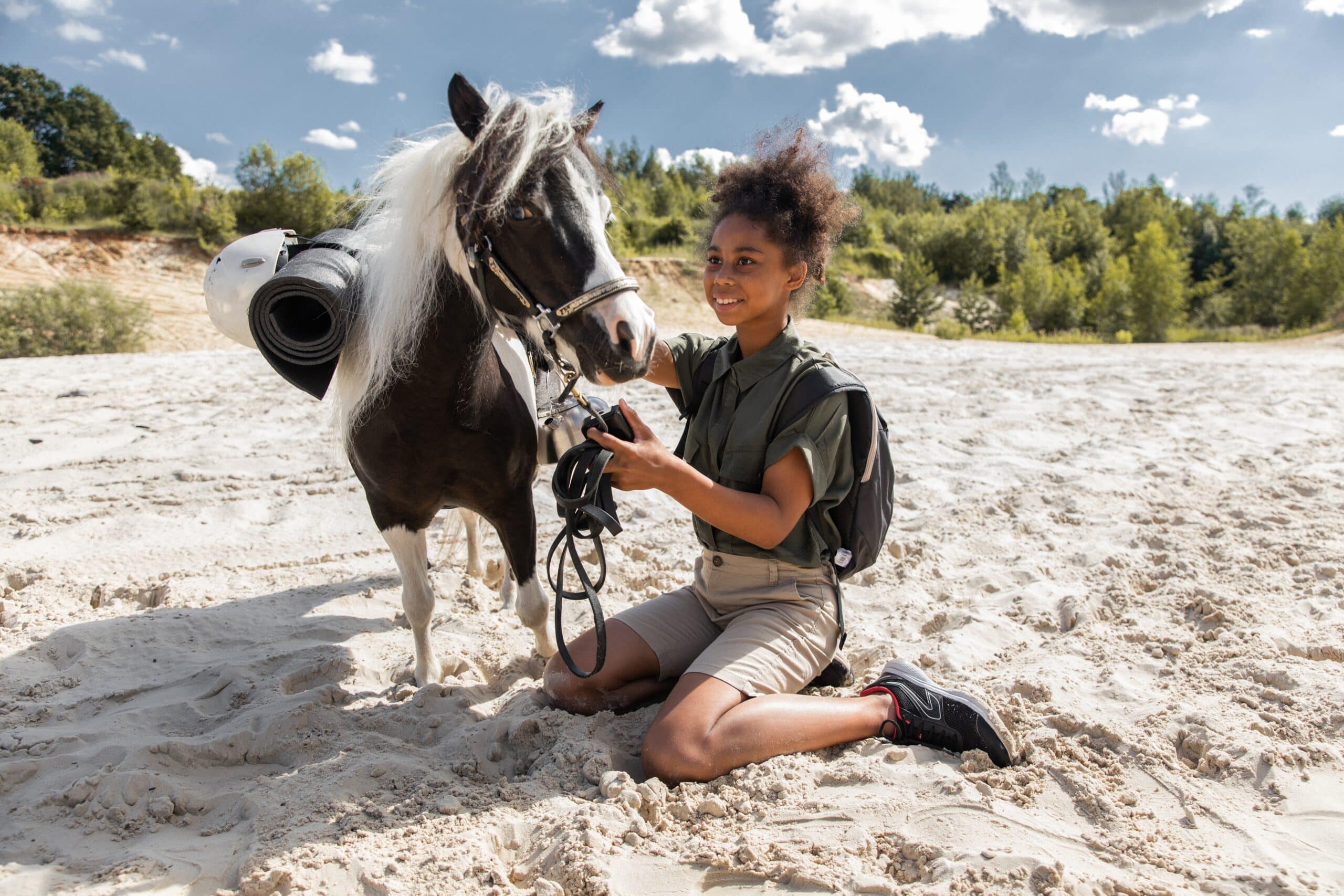 child with horse on beach