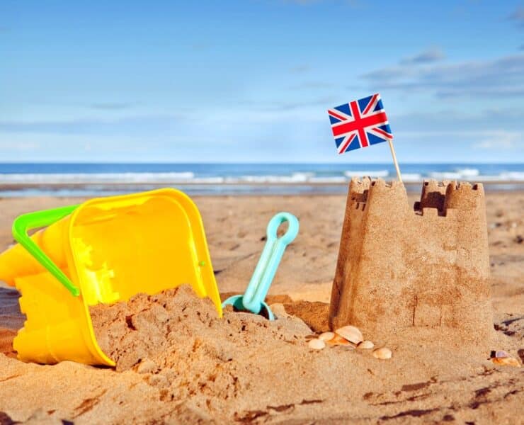 beach with buckets and sand castles
