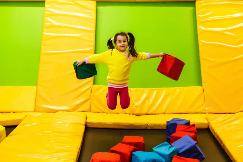 little girl playing with foam pit