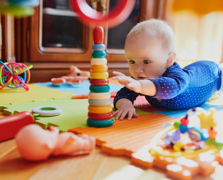 baby reaching out for toys