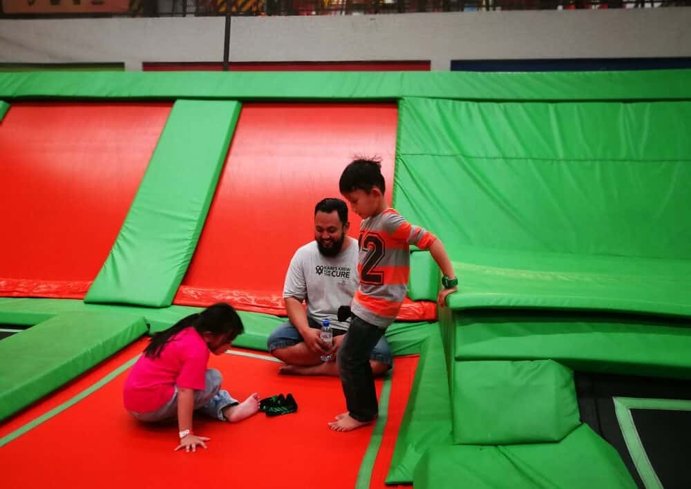 family on trampoline at trampoline park