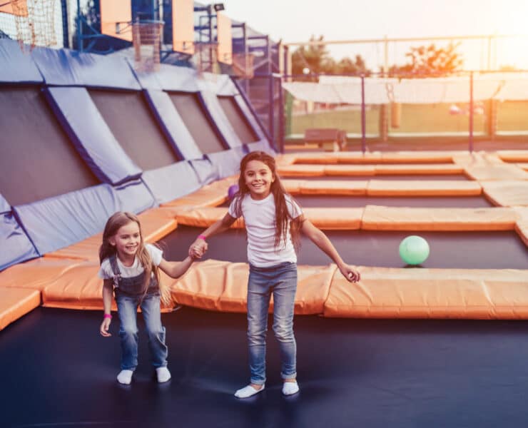 two kids on trampolines