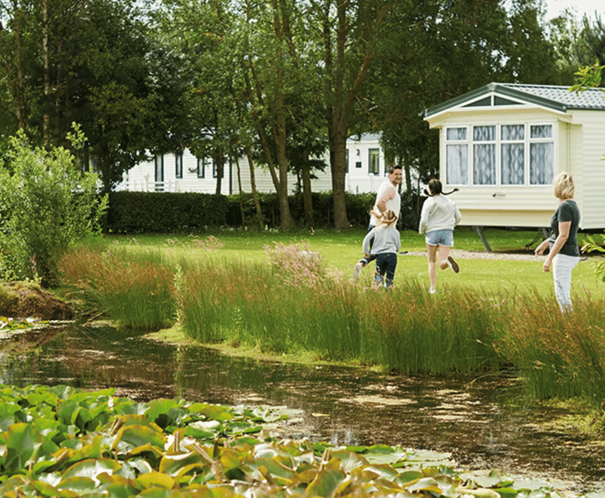 kids running around by a lake at haven