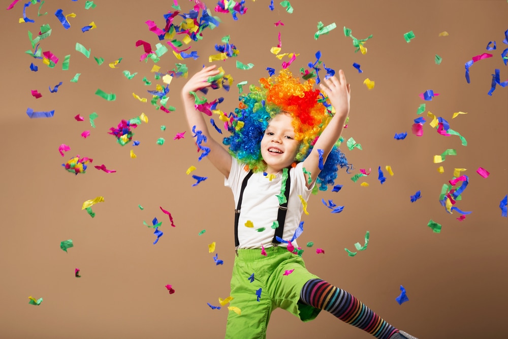 kids in clown costume throwing confetti