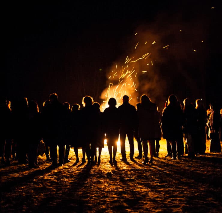People stood watching a bonfire