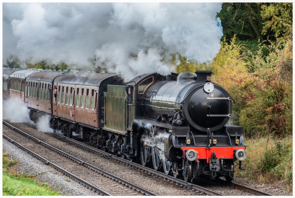 black and green steam train on train track