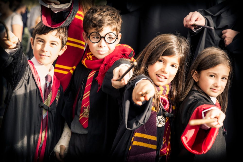 everyone dressed up as harry potter with capes and wands