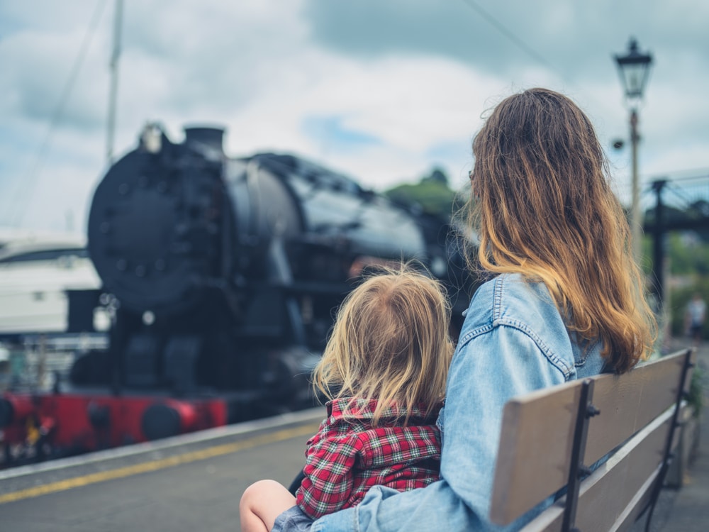 parent and son looking at the steam train