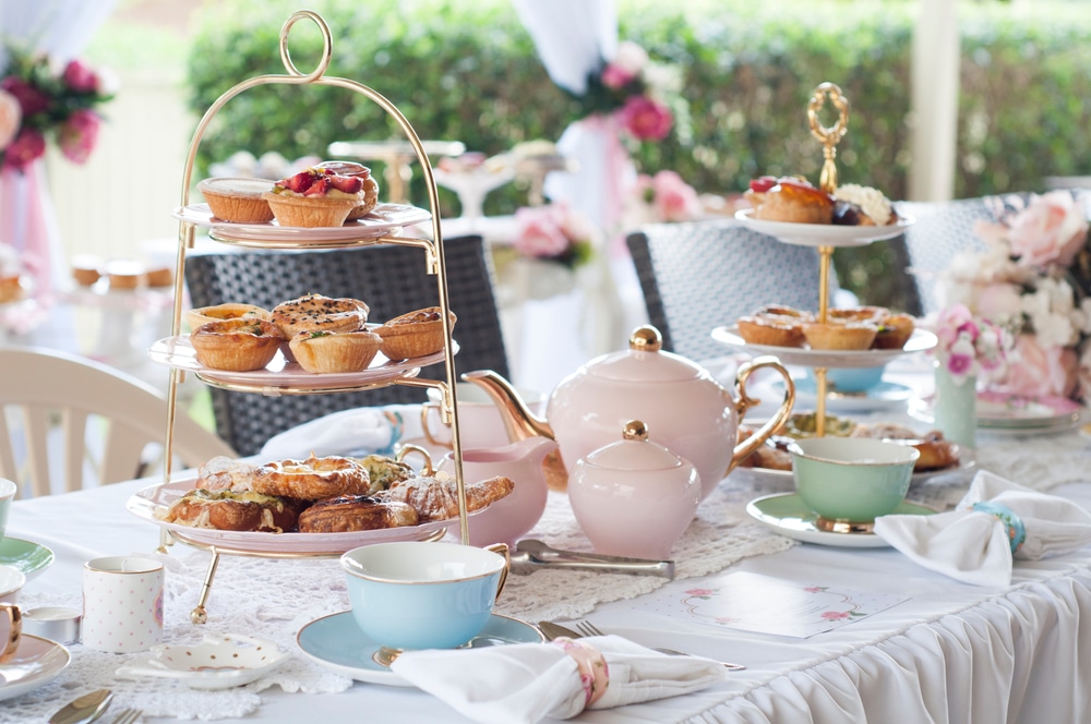 picture of afternoon tea with cakes, tea and sandwiches