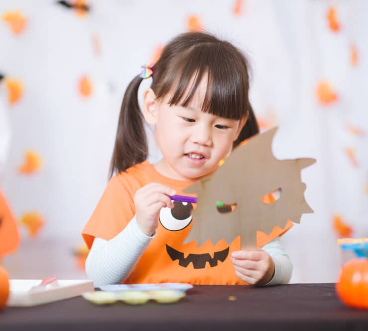 girl being crafty for halloween