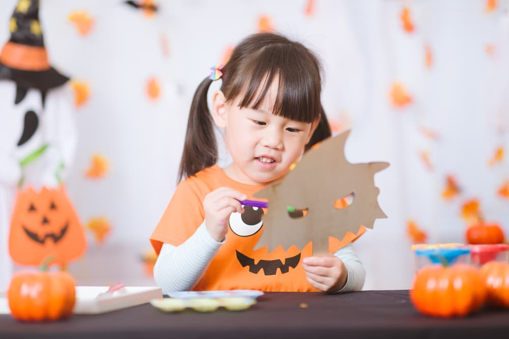girl being crafty for halloween
