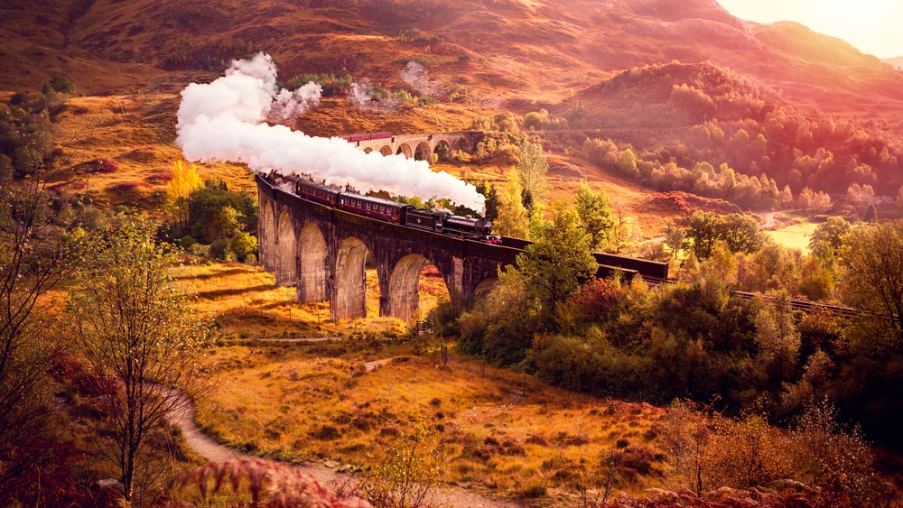 steam train along railway in countryside