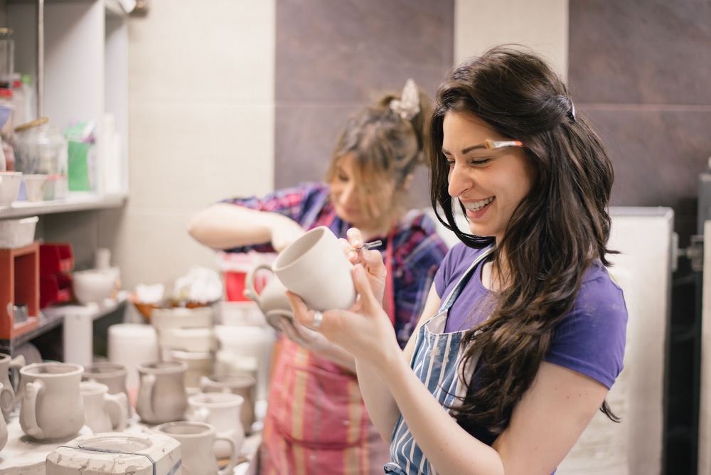 two adults pottery painting
