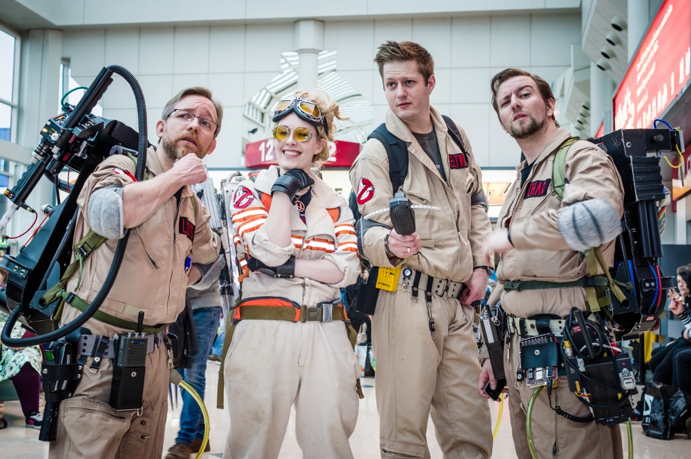 four people wearing the ghostbusters costume