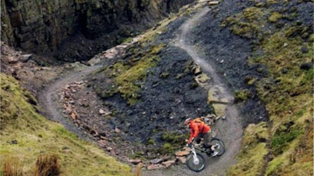 cyclist biking in a quarry