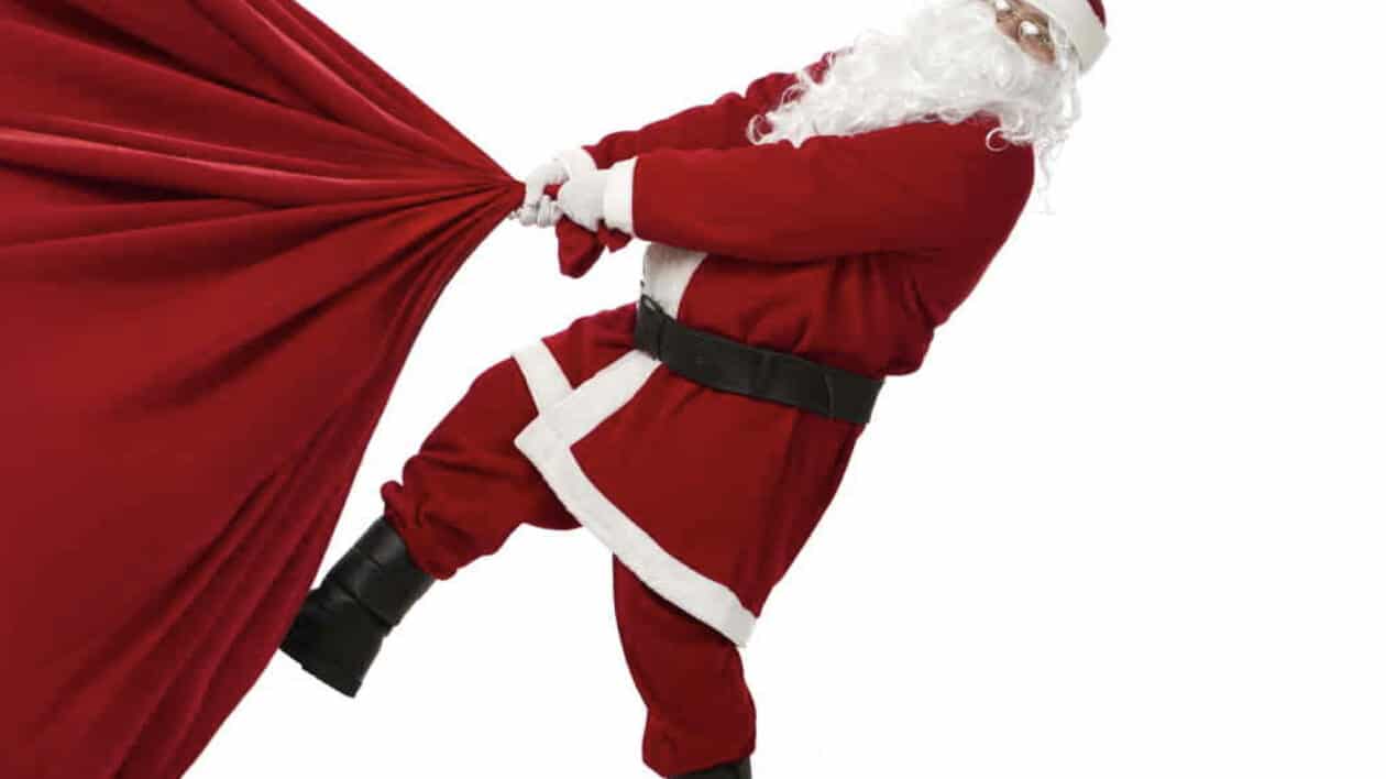 santa dragging a sack full of christmas gifts