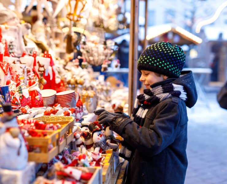boy looking at sweets in at a christmas market stalll