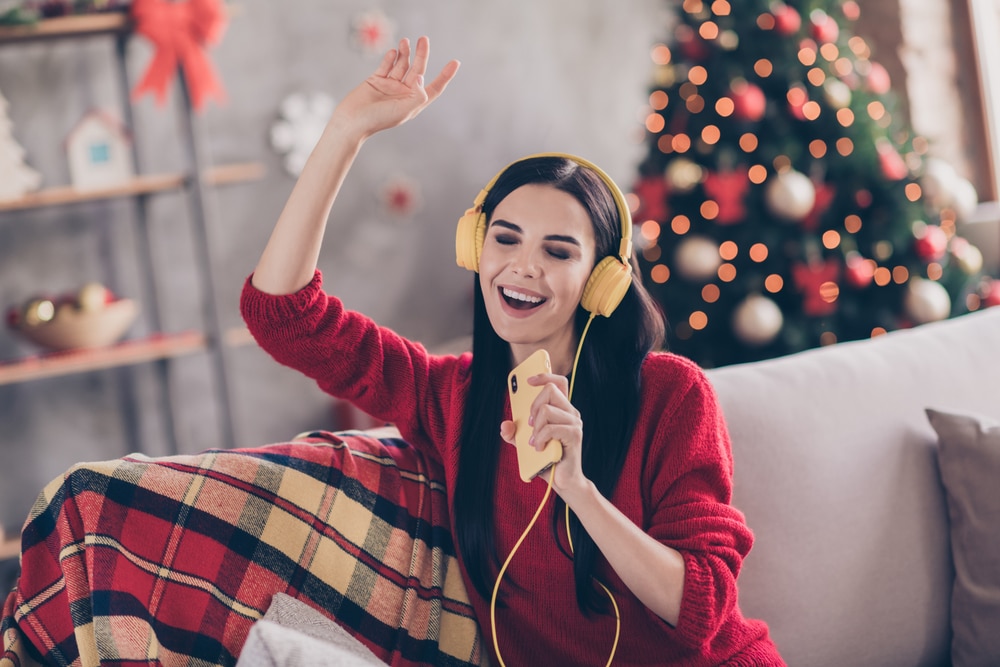 someone listening to a christmas song list