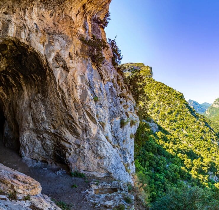 Cave surrounded by green mountains