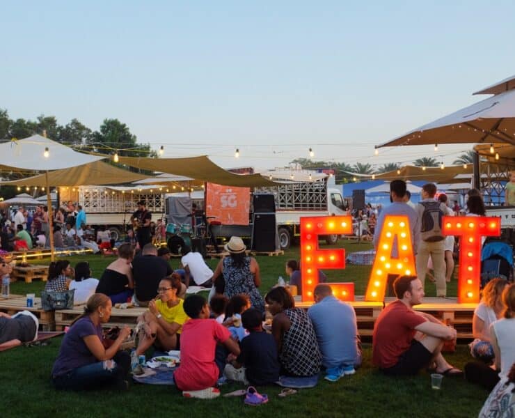 a food festival with a big light saying EAT