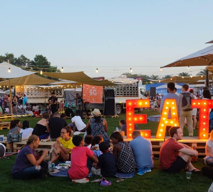 a food festival with a big light saying EAT