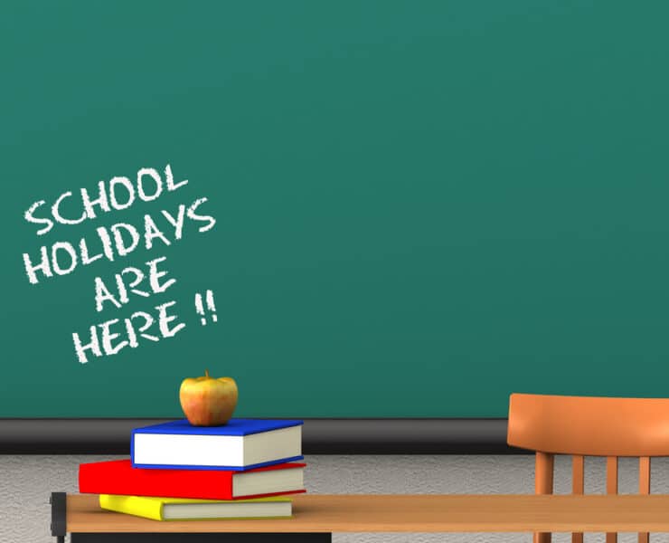 chalk board saying school holidays are here