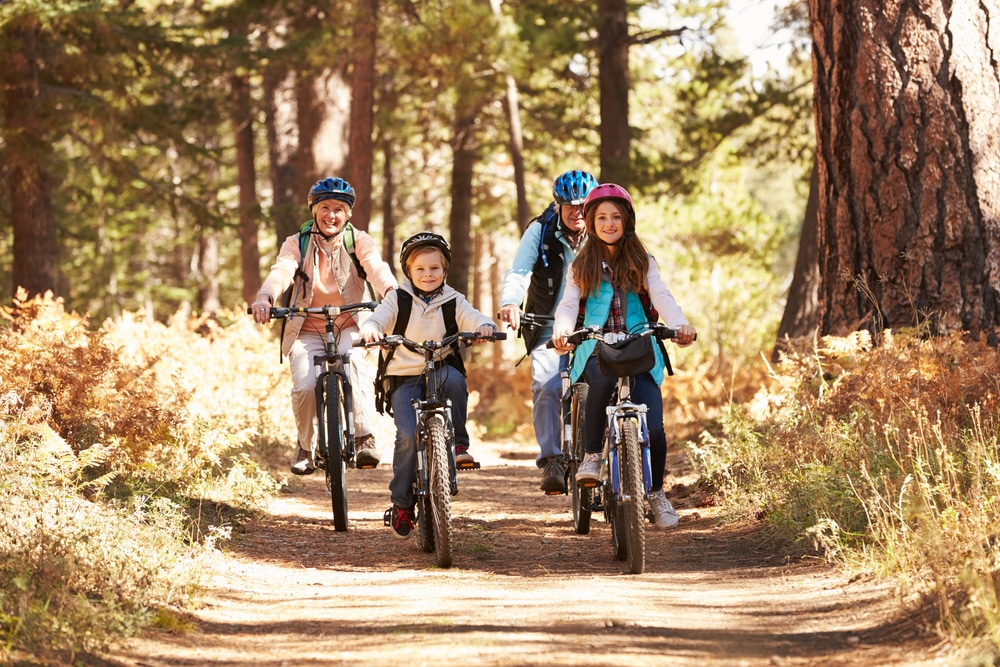 a family cycling in an autumn forest