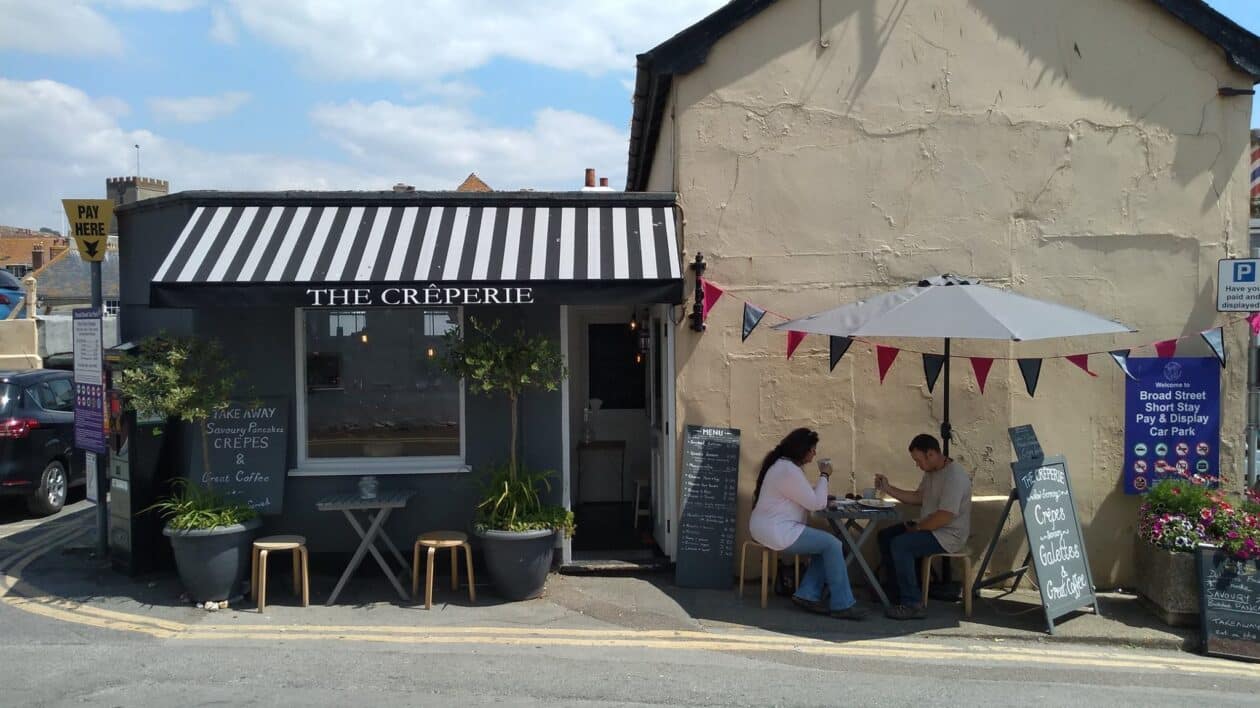 The Creperie shop front with people sitting outside