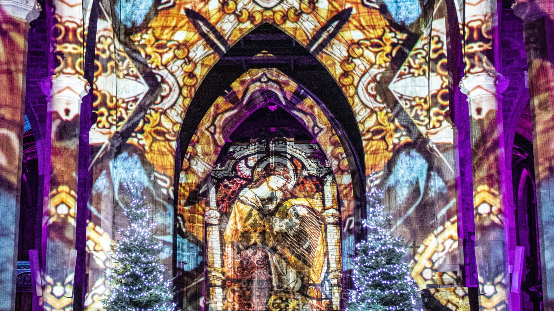 medieval artwork projected on the cathedral walls and pillar