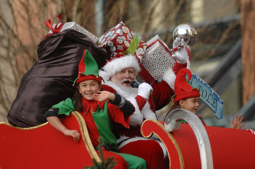 santa claus and elves giving presents