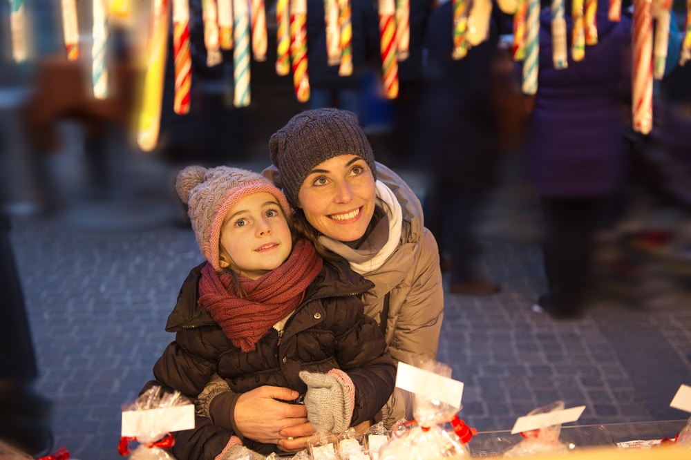 mother and daughter looking at sweets at food stall